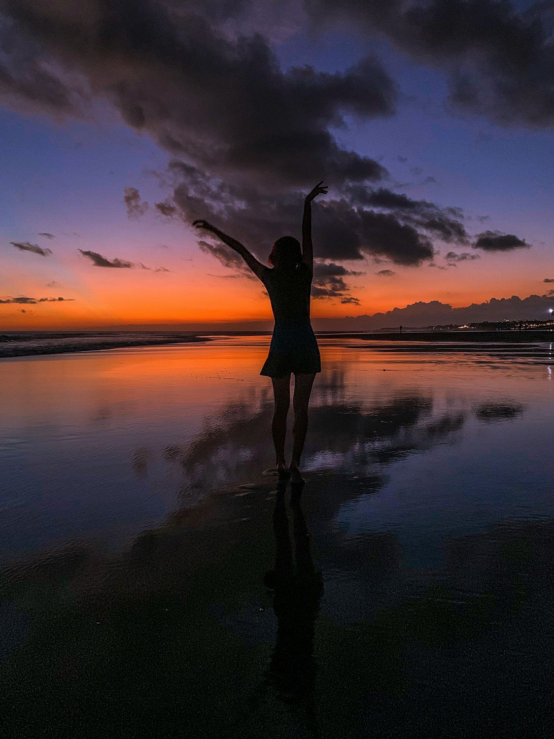A woman at sunset on a Bali beach